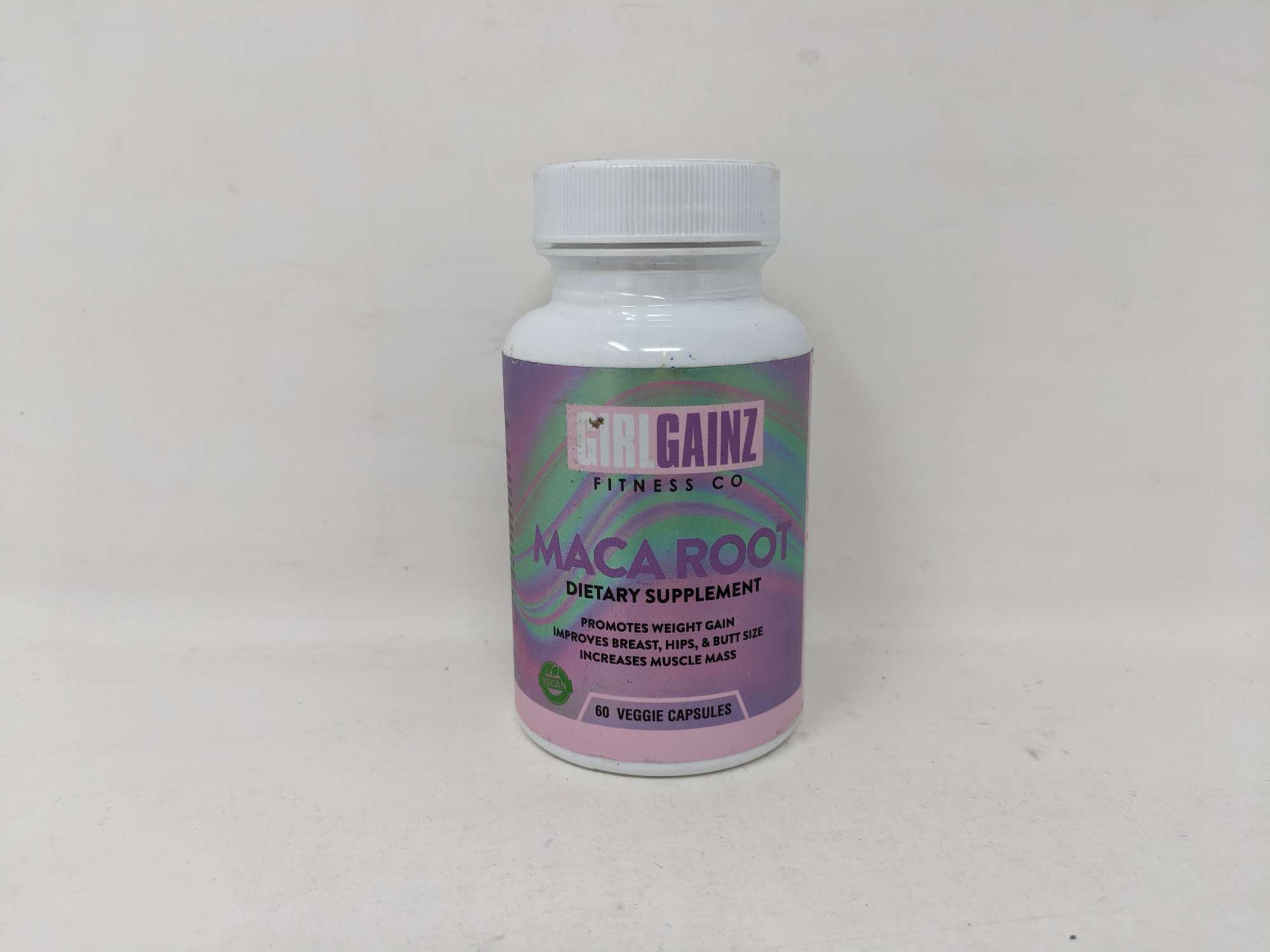 Bottle of Girl Gainz Maca Root dietary supplement promoting weight gain and curves
